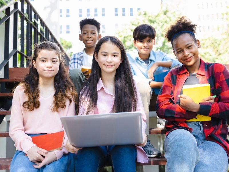 High school students of different races studying with laptops, diverse high school students